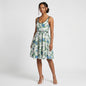 Model wearing a Lynn's Closet Boutique Anthropologie silk floral dress with blue botanical print and black trim.