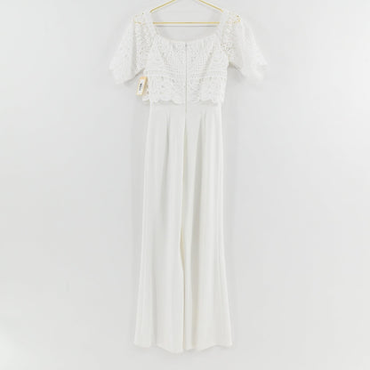 Lynn's Closet Boutique Antonio Melani white jumpsuit with off-the-shoulder crochet lace bodice and wide-leg trousers.