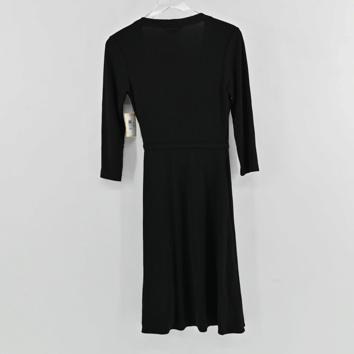 Lynn's Closet Boutique BCBGMaxAzria black wrap dress with three-quarter sleeves shown from the back on a hanger.