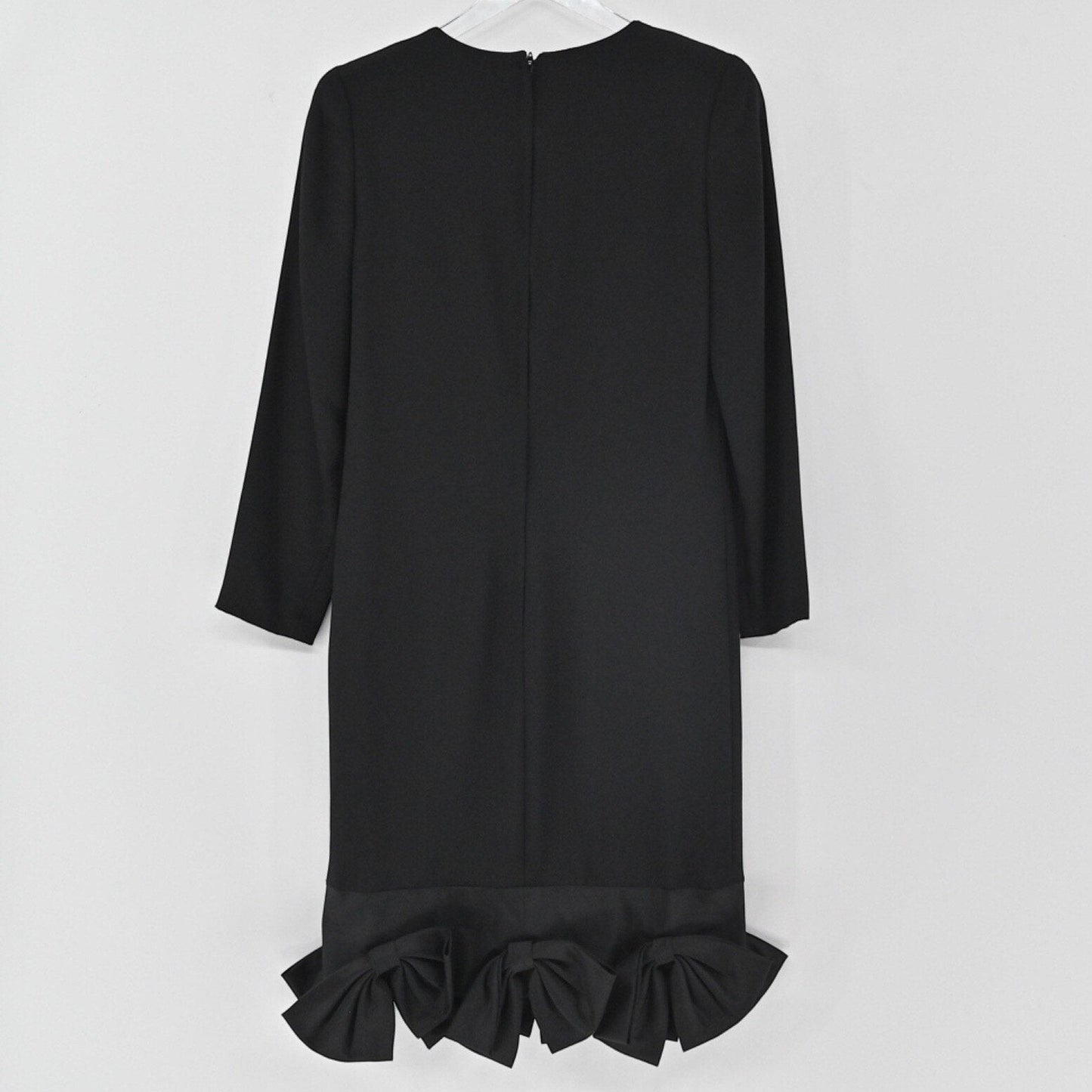 Lynn's Closet Boutique black long-sleeve shift dress featuring a structured bow hemline on a white background