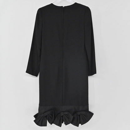 Lynn's Closet Boutique black long-sleeve shift dress featuring a structured bow hemline on a white background