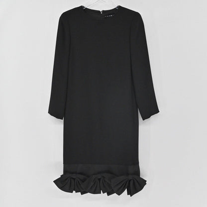 Lynn's Closet Boutique black long-sleeve shift dress featuring a round neckline and structured bows along the hem.