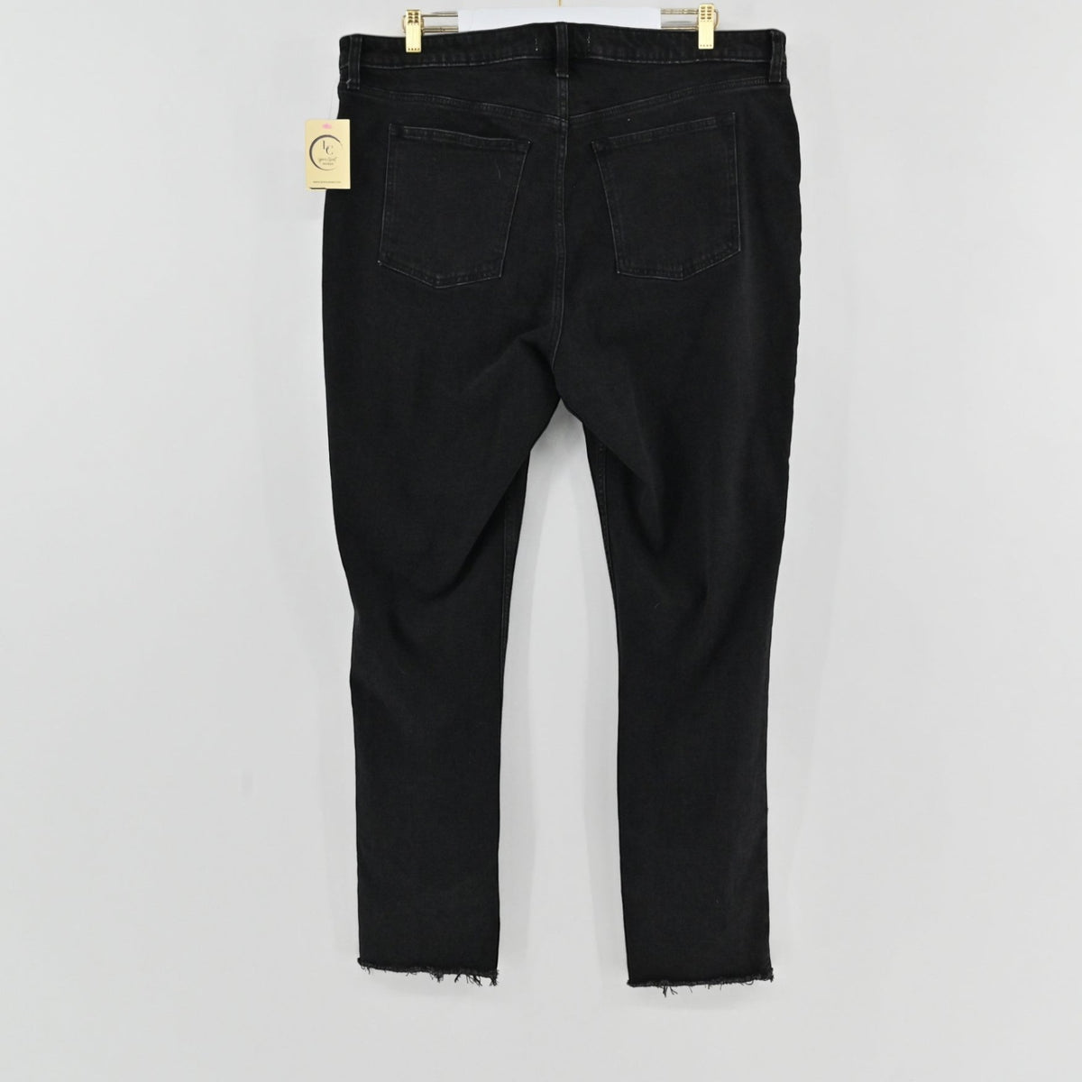 Lynn's Closet Boutique A&F Curve Love black denim pants featuring a high-rise waist and raw-edge hem, back view.