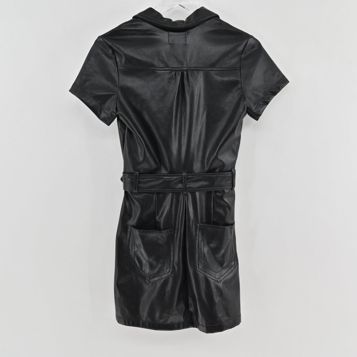 Lynn's Closet Boutique Show Me Your Mumu black faux leather mini dress with a belted waist and back pockets.