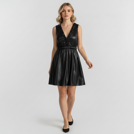 Model wearing a Lynn's Closet Boutique black faux leather mini dress with a V-neck, ruffle trim, and elastic waist.