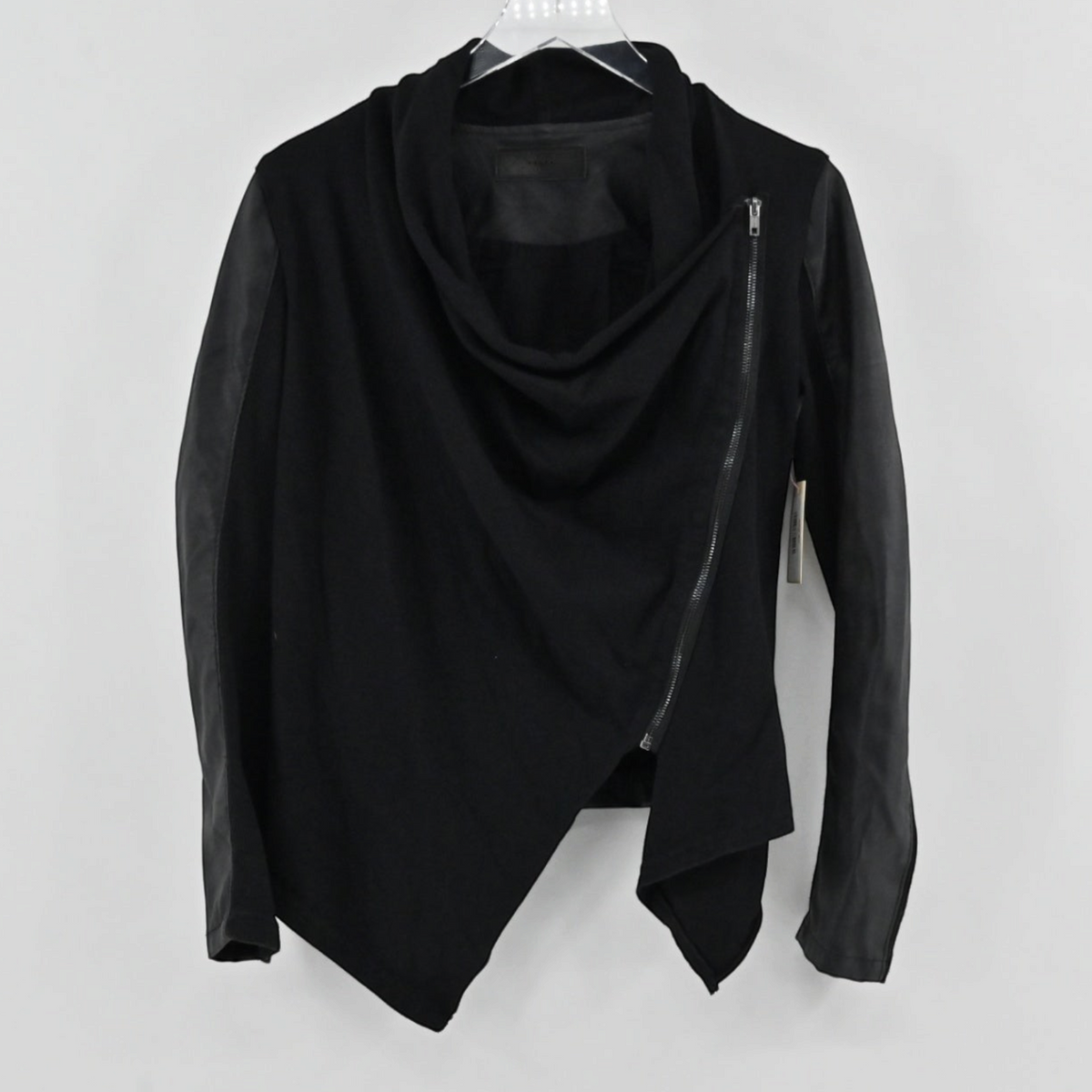 Lynn's Closet Boutique black Blank NYC moto jacket with faux leather sleeves and an asymmetrical draped front zipper.