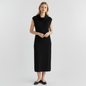 Model wearing a Lynn's Closet Boutique black sleeveless midi dress with a cowl neckline in a minimalist studio setting.