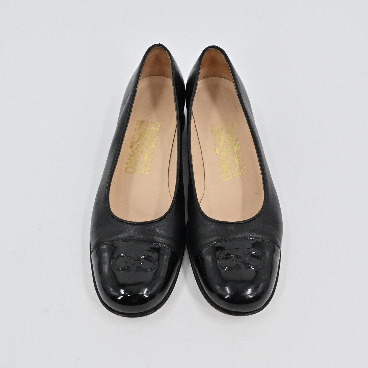 Lynn's Closet Boutique Salvatore Ferragamo black leather pumps with patent cap toe and embossed Gancini logo