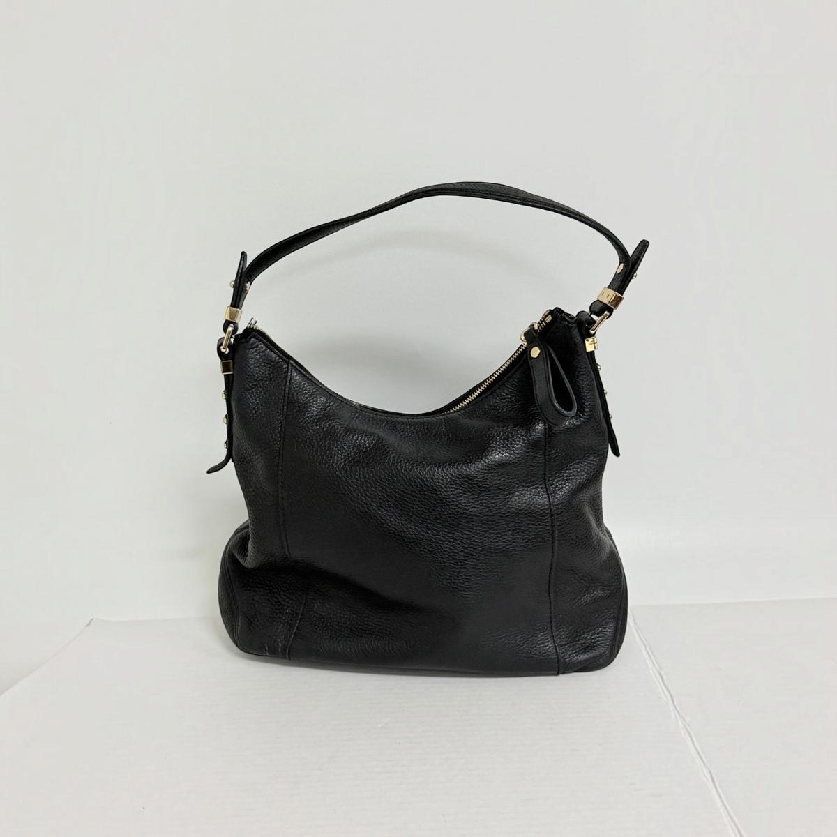 Lynn's Closet Boutique black pebbled leather Michael Kors tote bag with gold-tone hardware and top-zip closure.