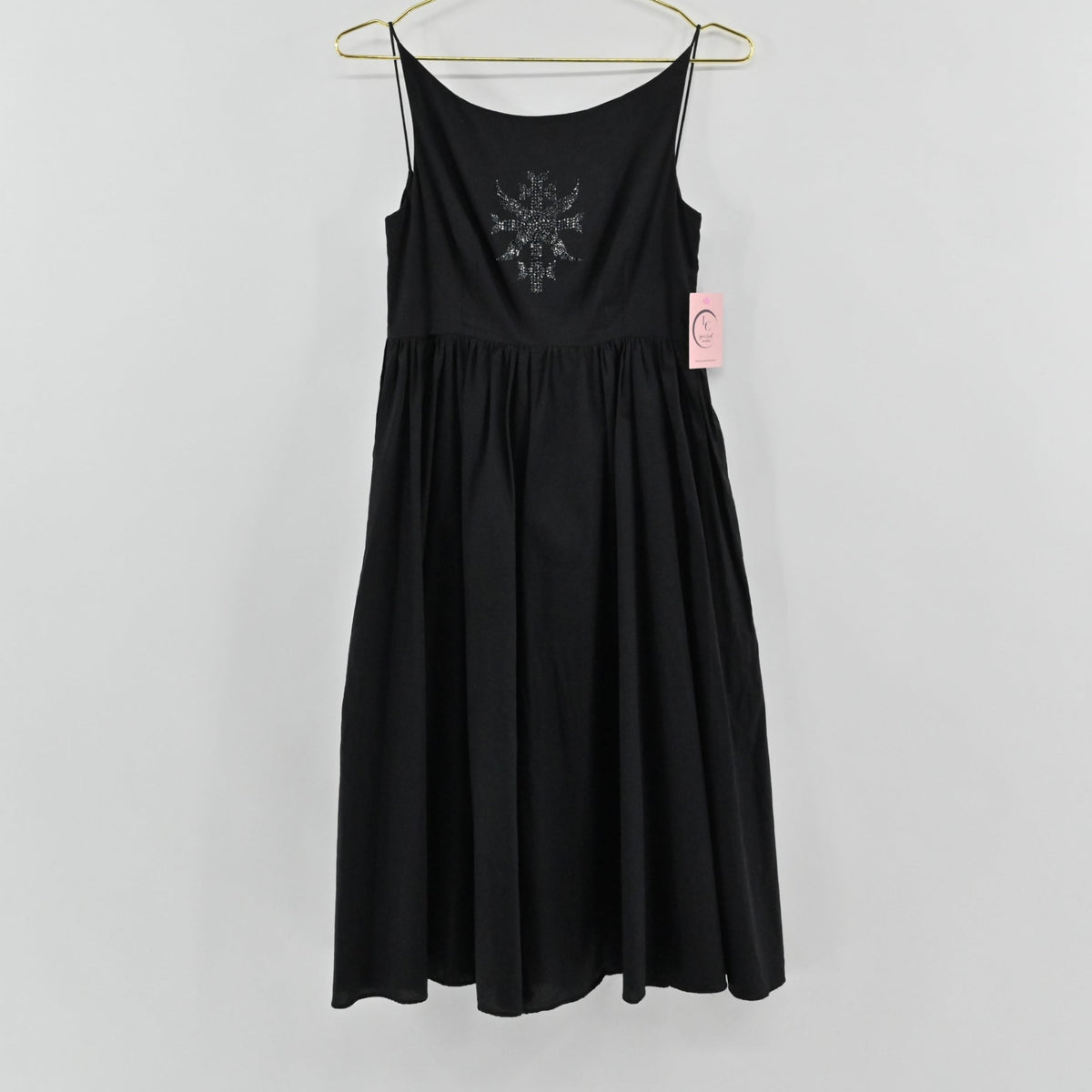 Lynn's Closet Boutique black midi dress with spaghetti straps, gathered waist, and embellished bodice motif.
