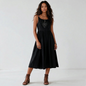 Lynn's Closet Boutique black midi dress with spaghetti straps, gathered waist, and embellished bodice on a model