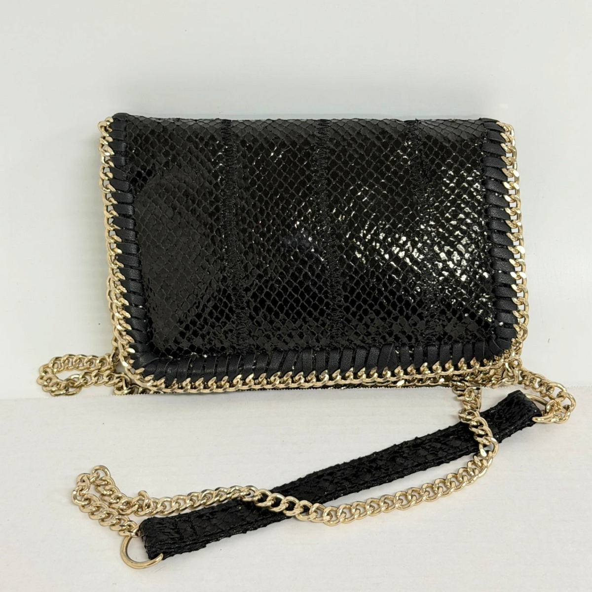Lynn's Closet Boutique black snakeskin-embossed clutch with gold-tone chain trim and shoulder strap