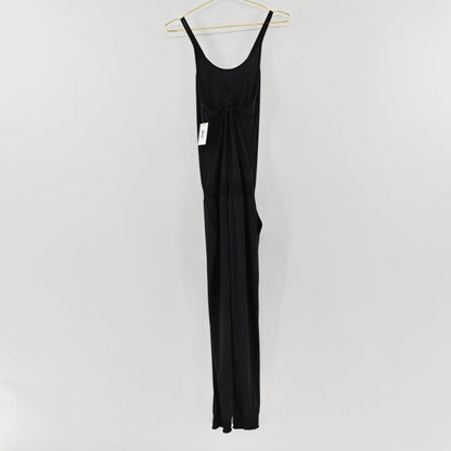 Lynn's Closet Boutique black Sweaty Betty strappy jumpsuit with a scoop back and jogger cuffs hanging on a hanger.