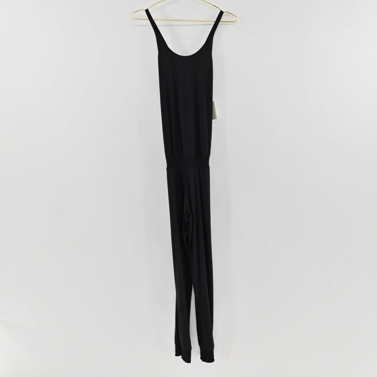 Lynn's Closet Boutique Sweaty Betty black strappy jumpsuit with a scoop back and jogger-style cuffs on a hanger.