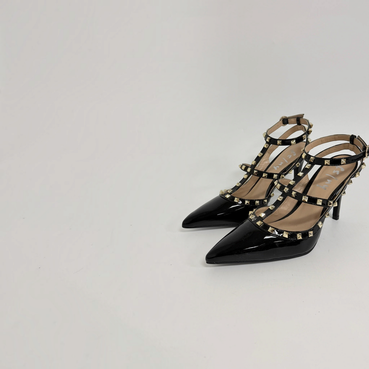 Lynn's Closet Boutique black patent leather heels with gold pyramid studs, pointed toe, and cage strap design.