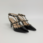 Lynn's Closet Boutique black patent pointed-toe heels with gold pyramid studs and multi-strap cage design.