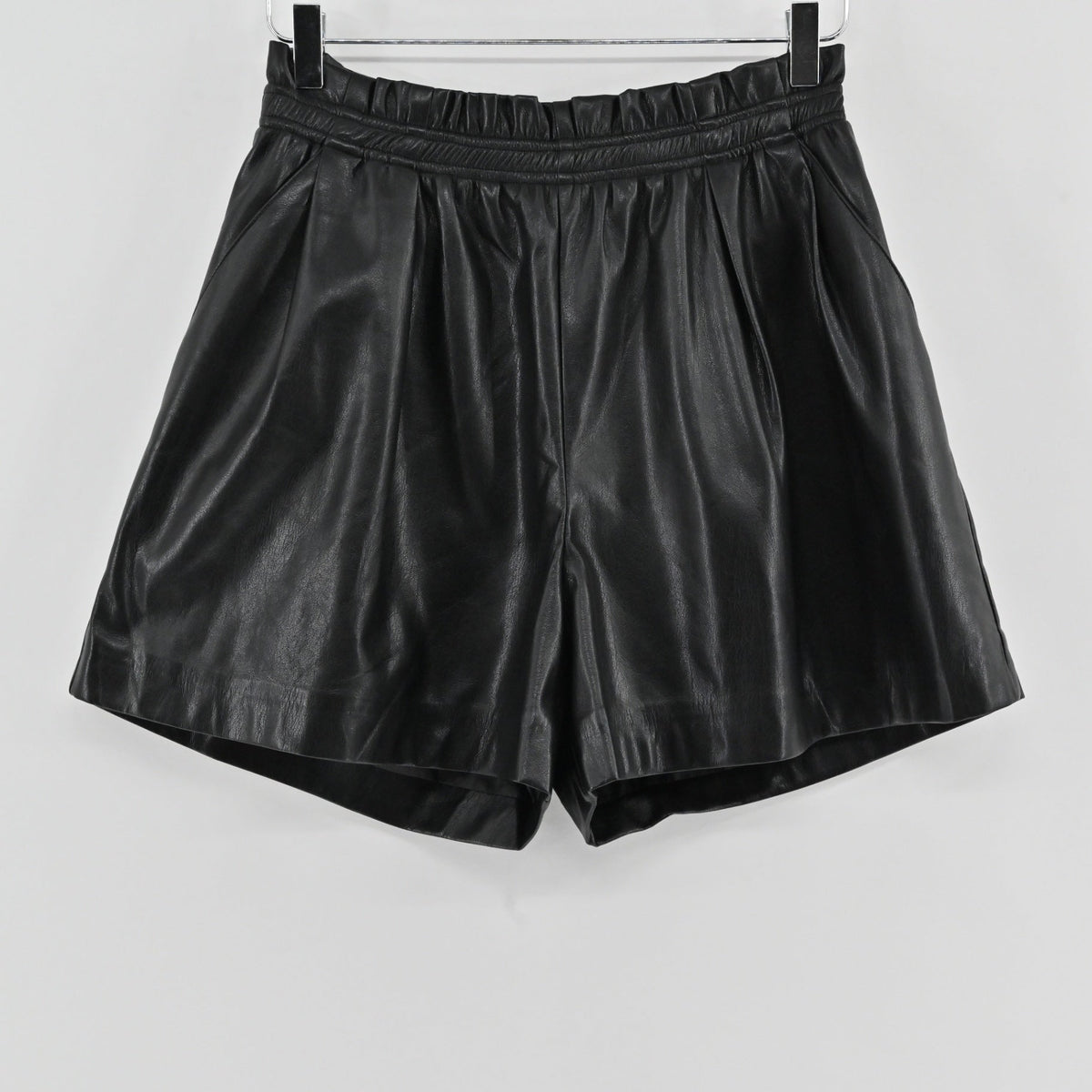 Lynn's Closet Boutique black vegan leather shorts with a high-waisted paperbag elasticated waistband and side pockets.
