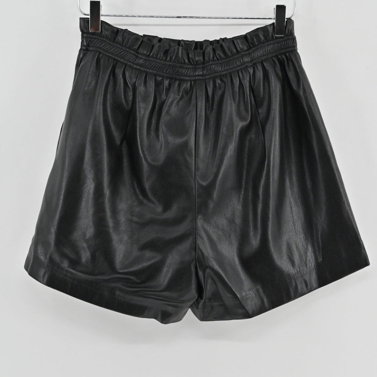 Lynn's Closet Boutique black vegan leather shorts with a high-waisted paperbag elasticated waistband and side pockets.