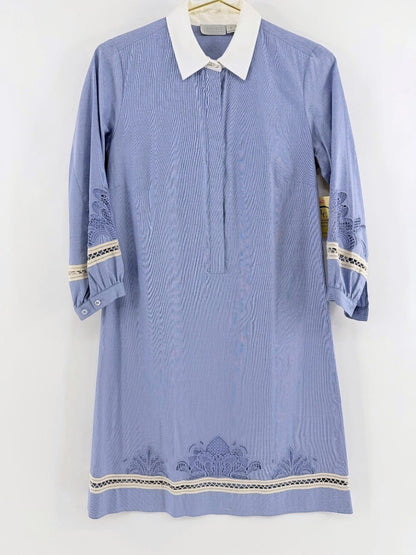 Lynn's Closet Boutique blue chambray dress with white collar, lace trim, and intricate embroidery on sleeves and hem.