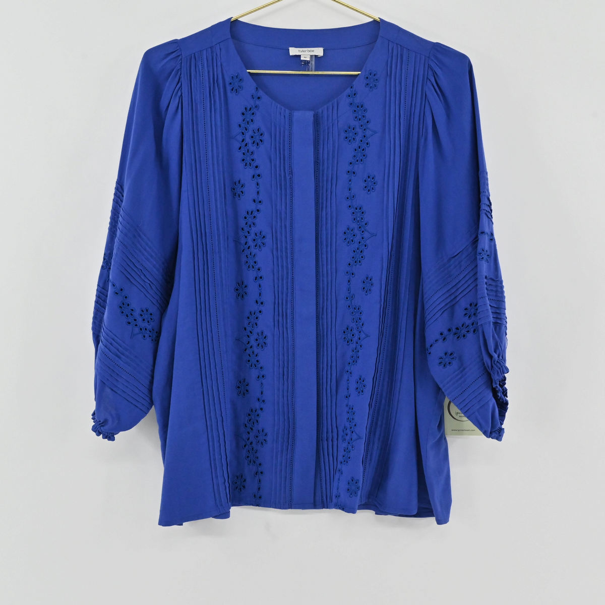 Lynn's Closet Boutique blue Tyler Boe eyelet blouse with vertical pleating and three-quarter length sleeves