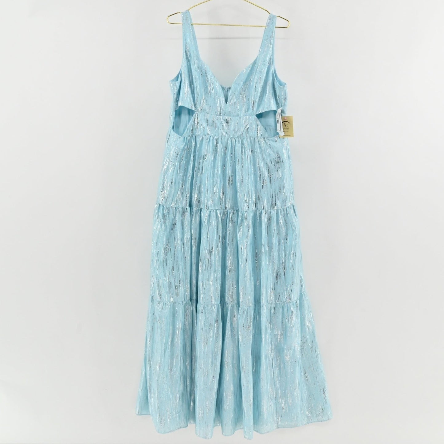 Lynn's Closet Boutique sky blue metallic maxi dress with V-neck, side cut-outs, and tiered skirt on a hanger.