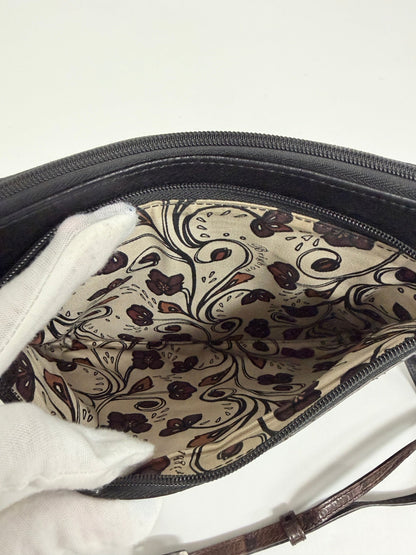 Interior of Lynn's Closet Boutique Brighton crossbody bag featuring a cream fabric lining with a brown floral pattern.
