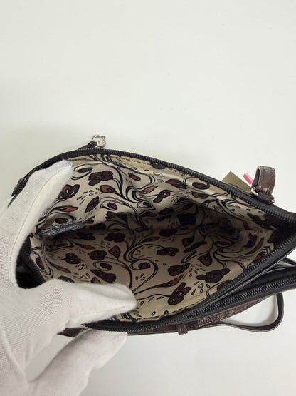 Lynn's Closet Boutique Brighton crossbody bag interior featuring a decorative floral pattern lining and zipper closure