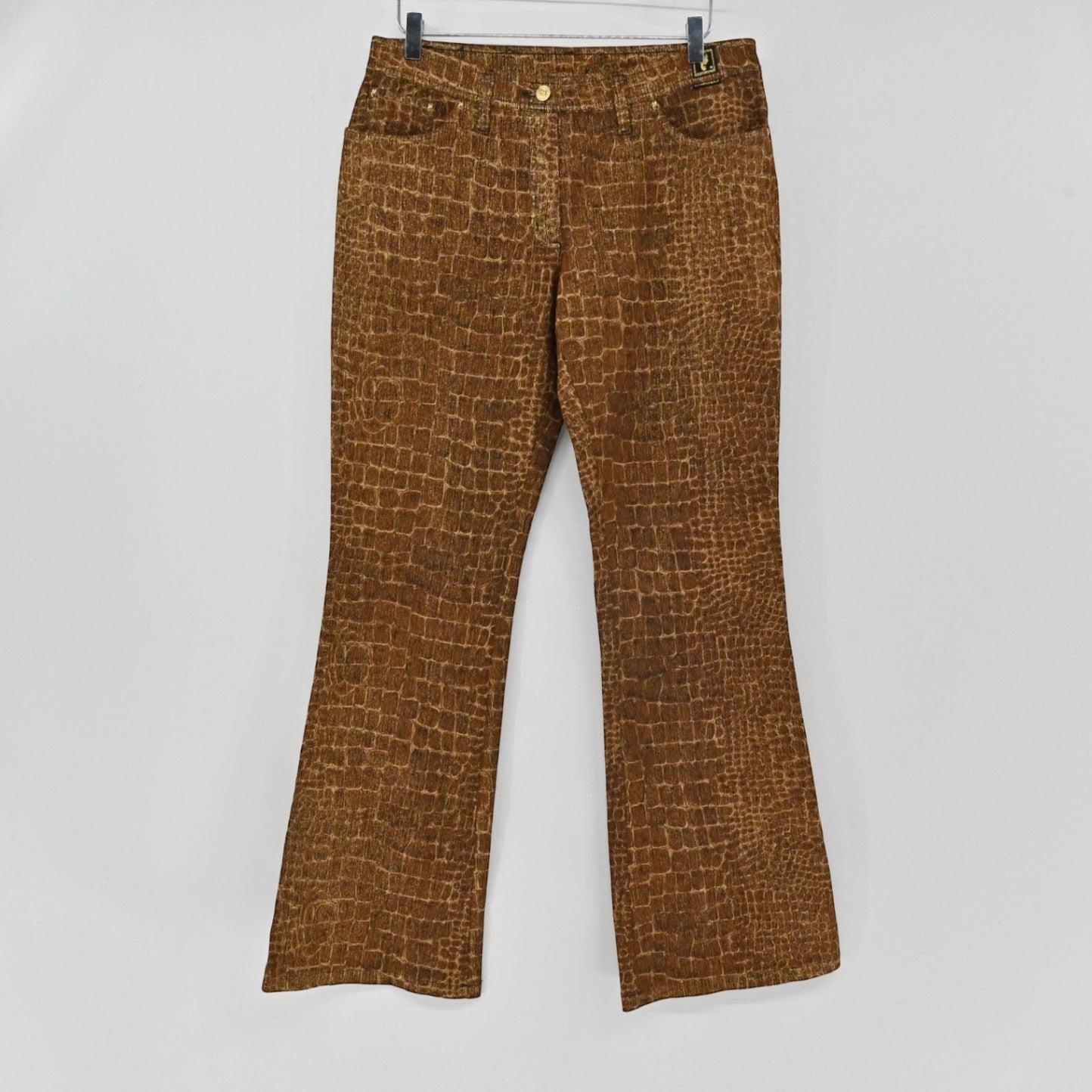 Lynn's Closet Boutique brown croc-embossed jeans with a classic cut and button-fly closure hanging on a hanger.