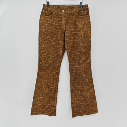 Lynn's Closet Boutique brown croc-embossed jeans with a classic cut and button-fly closure hanging on a hanger.