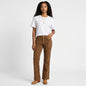 Model wearing Lynn's Closet Boutique Cappopera jeans with brown croc-embossed texture and a white t-shirt