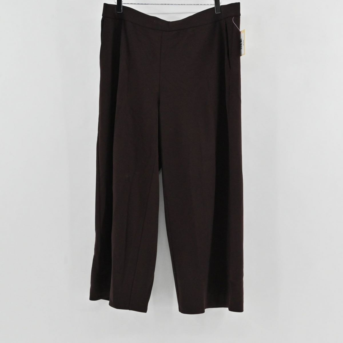 Lynn's Closet Boutique Eileen Fisher brown wide-leg knit pants with a pull-on waist, shown hanging against a white wall.