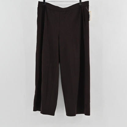 Lynn's Closet Boutique Eileen Fisher brown wide-leg knit pants with a pull-on waist, shown hanging against a white wall.