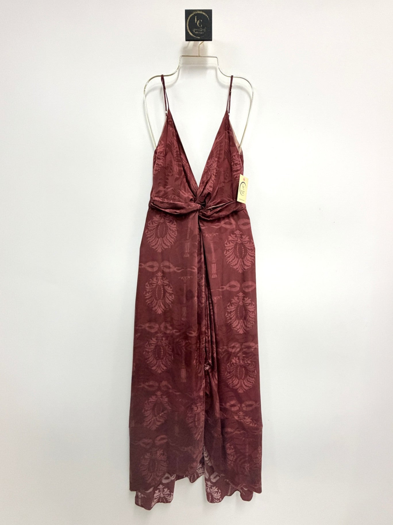 Lynn's Closet Boutique burgundy silk maxi dress with plunging V-neck, front-twist detail, and tonal jacquard pattern.