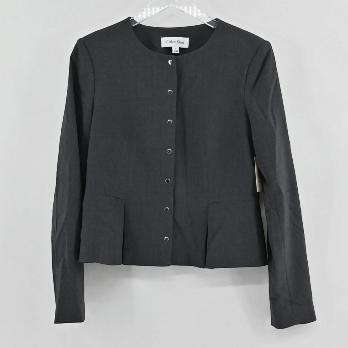 Lynn's Closet Boutique Calvin Klein charcoal gray collarless button-front jacket with pleated hem detail