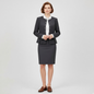 Lynn's Closet Boutique Calvin Klein charcoal gray collarless skirt suit with button-front jacket on a model.