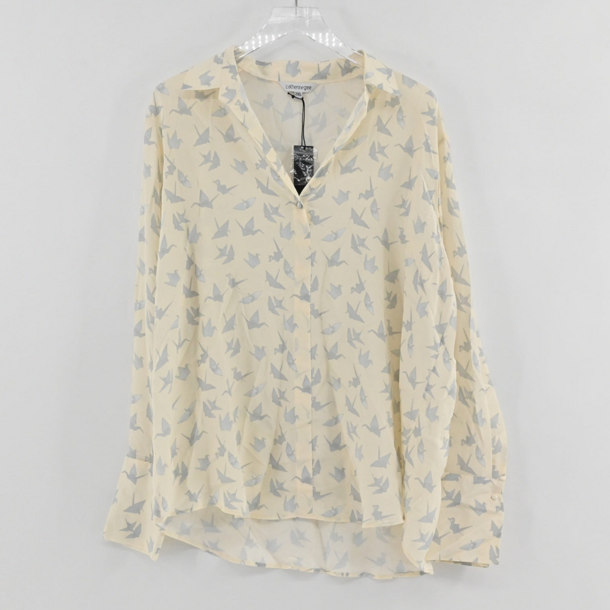 Lynn's Closet Boutique Catherine Gee cream long-sleeve blouse with a grey origami crane print and button-front design.