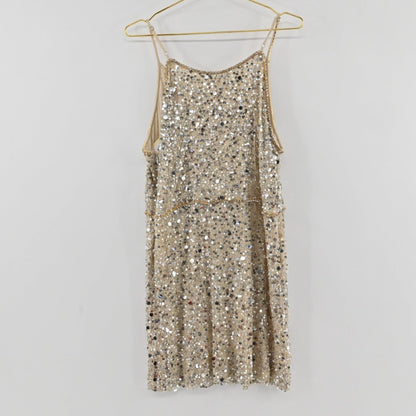 Lynn's Closet Boutique Anthropologie Verb champagne sequin shift dress with spaghetti straps hanging on a gold hanger.