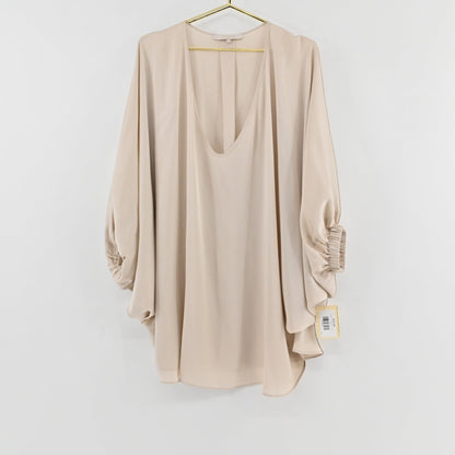 Lynn's Closet Boutique champagne silk top with deep V-neck, billowy sleeves, and gathered cuffs on a gold hanger.
