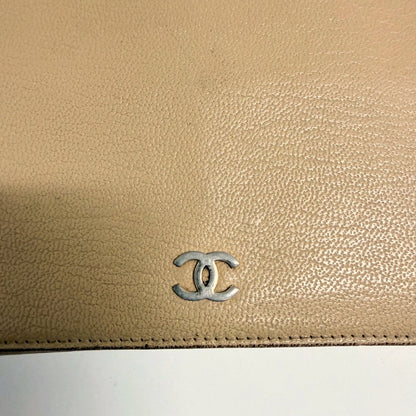 Lynn's Closet Boutique beige leather Chanel bi-fold wallet featuring a silver CC logo on the textured exterior.