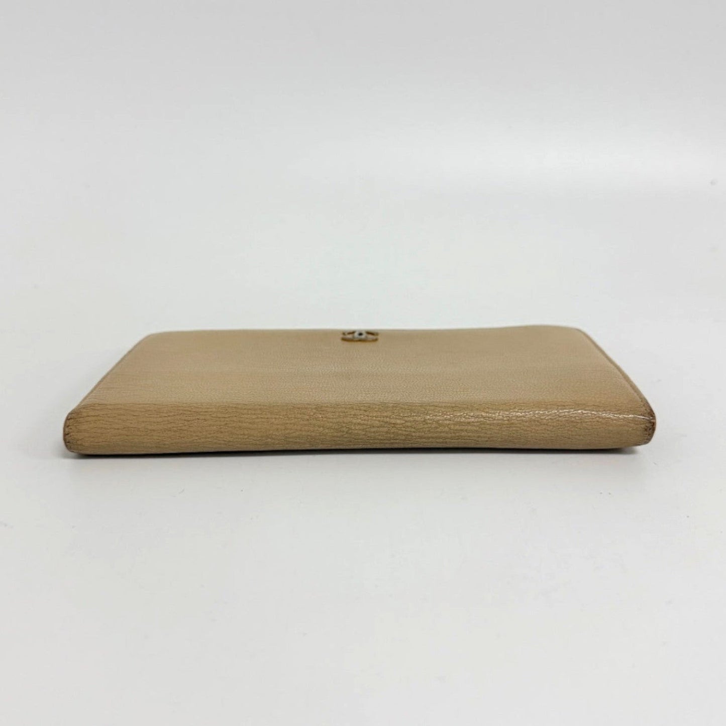 Lynn's Closet Boutique pre-owned beige leather Chanel bi-fold wallet with CC logo, side profile view.