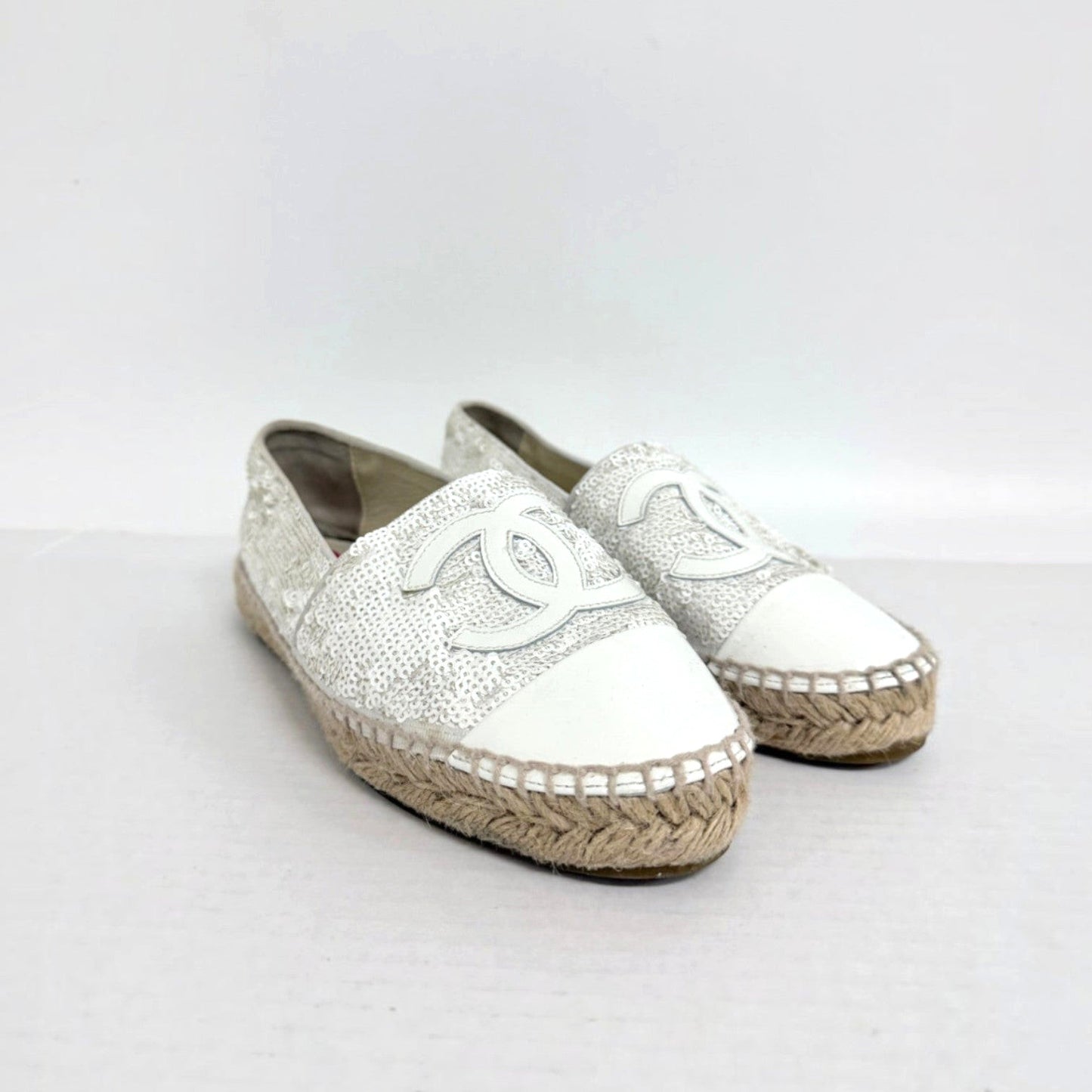 Lynn's Closet Boutique white sequin Chanel espadrilles with CC logo, leather toe cap, and jute sole.