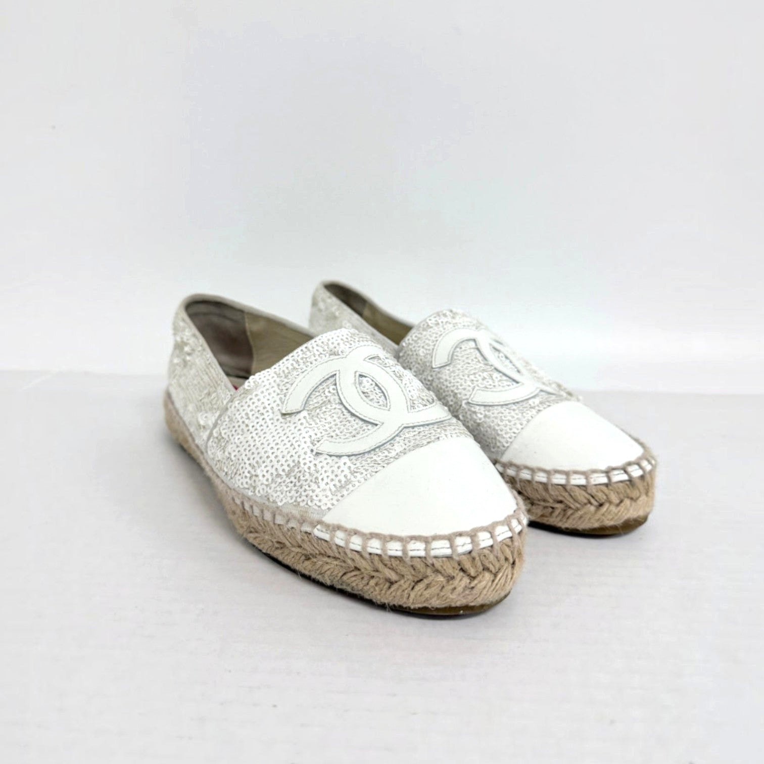 Lynn's Closet Boutique white sequin Chanel espadrilles with CC logo, leather toe cap, and jute sole.