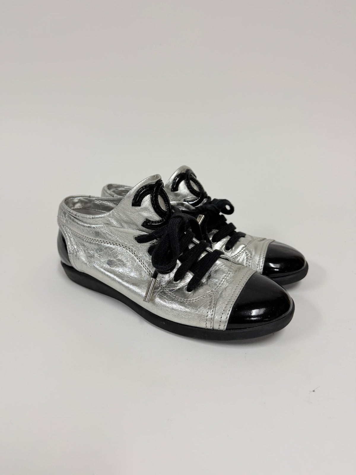 Lynn's Closet Boutique Chanel metallic silver lambskin sneakers with black patent cap toe and CC logo on tongue