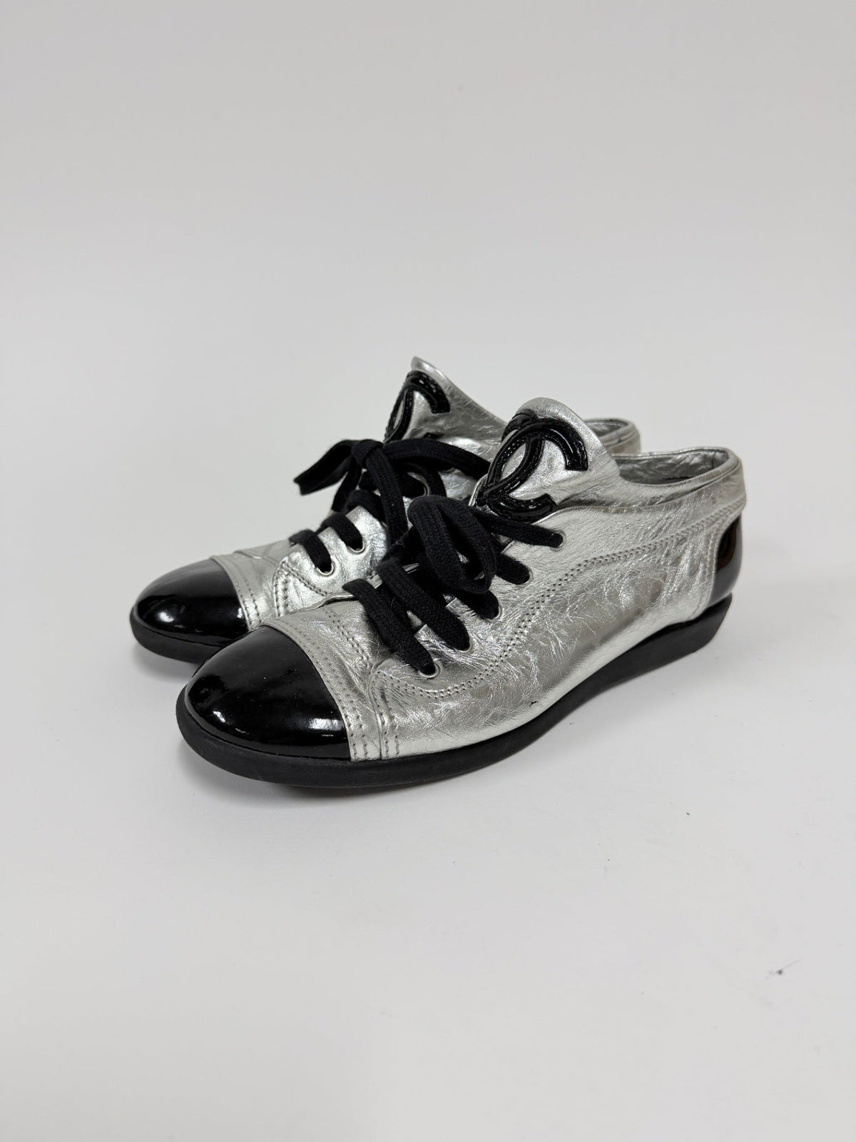 Lynn's Closet Boutique metallic silver lambskin Chanel sneakers with black patent cap toes and CC logo detail