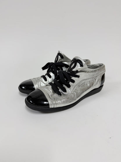 Lynn's Closet Boutique metallic silver lambskin Chanel sneakers with black patent cap toes and CC logo detail