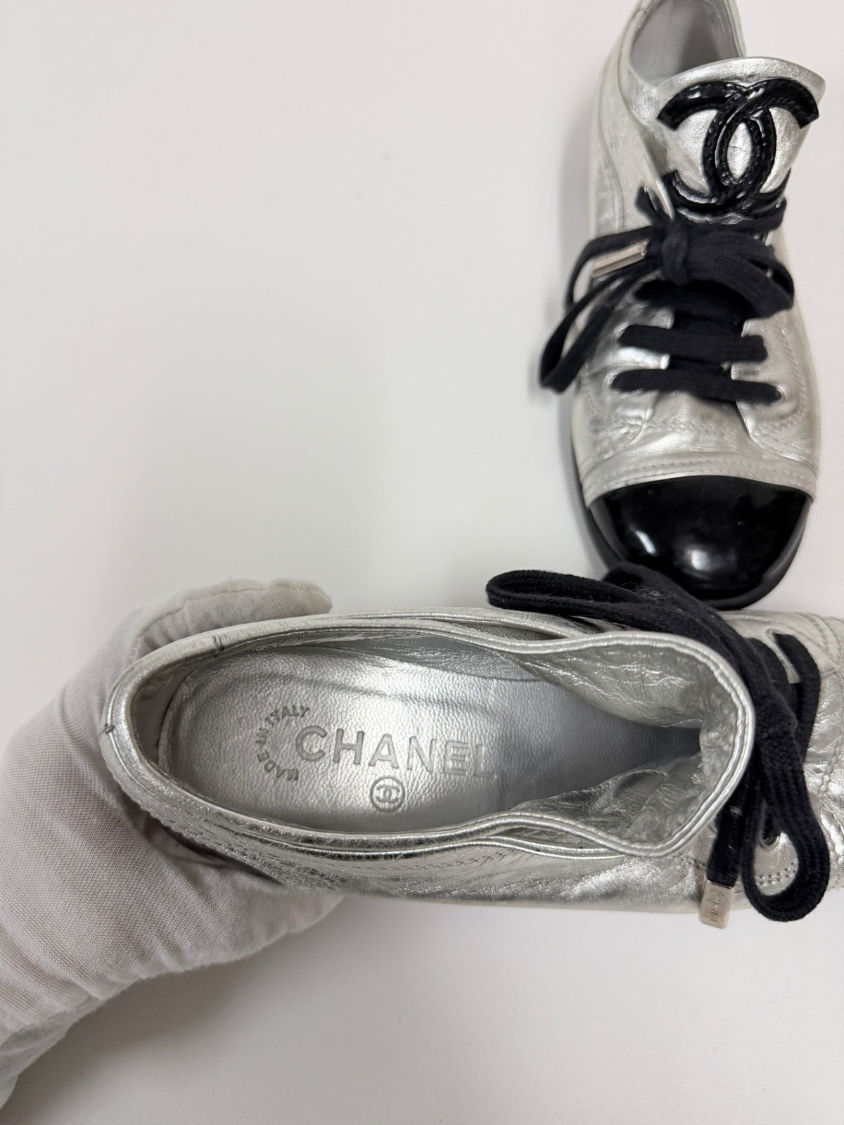 Lynn's Closet Boutique Chanel metallic silver lambskin sneakers with black patent cap toe and CC logo detail