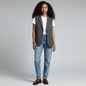 Model wearing a Lynn's Closet Boutique charcoal grey pinstripe vest over a white t-shirt and blue jeans