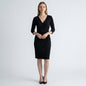 Lynn's Closet Boutique Chicos Travelers black faux wrap dress with three-quarter sleeves on a model