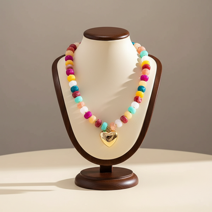 Lynn's Closet Boutique chunky acrylic bead necklace with a gold-tone heart pendant on a display bust