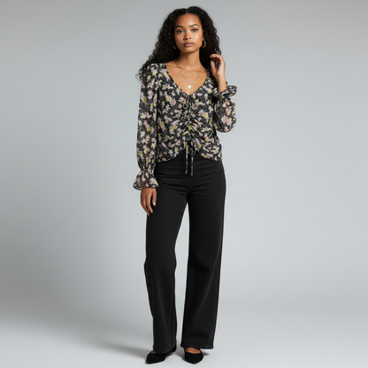 Lynn's Closet Boutique Cinq a Sept floral top with ruched front, V-neck, and ruffle cuffs worn with black jeans